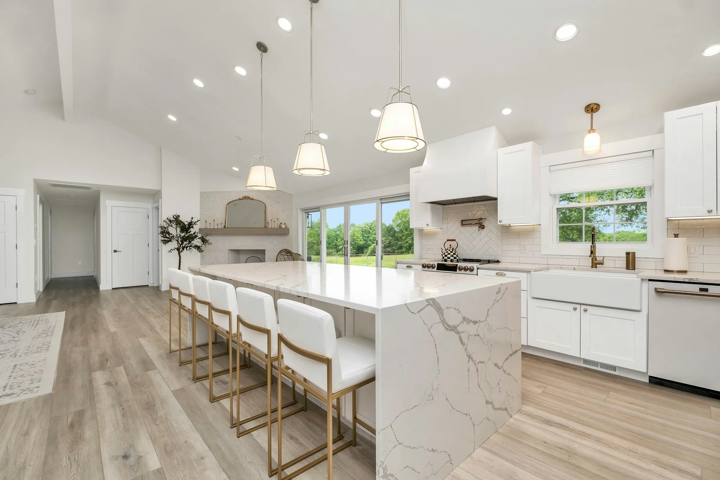 A bright, spotless open-plan kitchen with a marble island